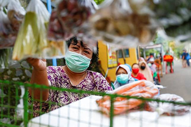 People practice social distancing while buying vegetables amid the COVID-19 outbreak in Depok, West Java, on April 28.