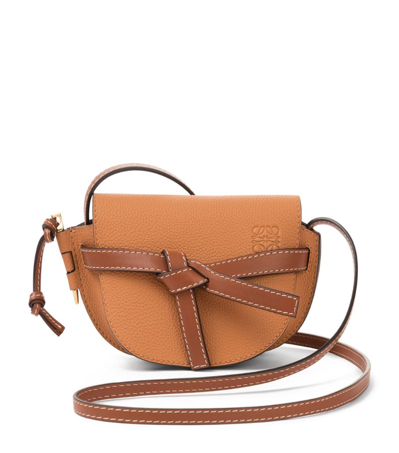 Owing its name to the side latched pin and knotted front belt closure, the coveted LOEWE Gate bag reimagines timeless functionality with a contemporary feel. The saddle-shaped cross-body style is handcrafted in soft leather to retain the structure, while the iconic Anagram is embossed to the front for a sleek and refined finish.