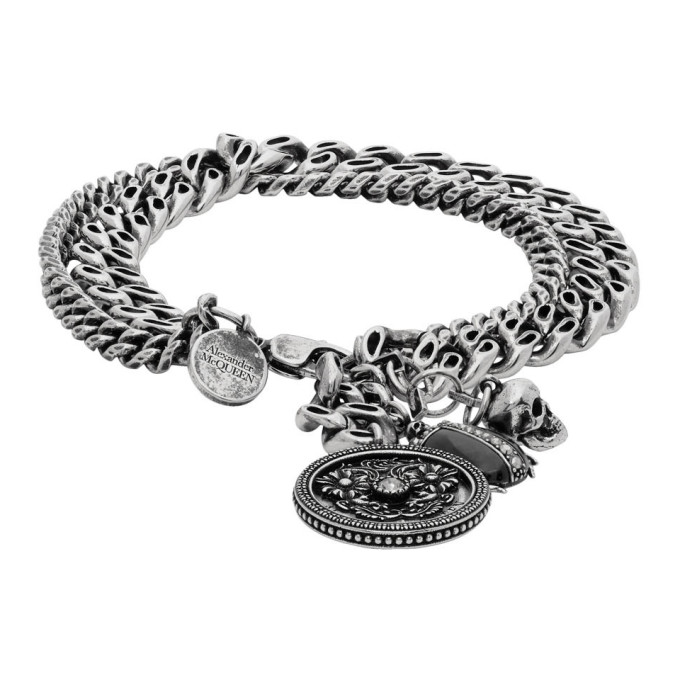 Curb chain bracelet in antiqued silver-tone brass. Signature skull hardware, engraved medallion, and