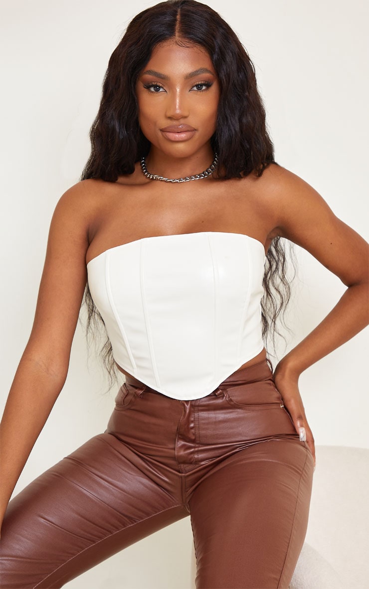 Cream PU Curved Hem Cropped Corset nThis cropped corset is endlessly versatile doll Featuring a crea