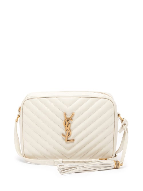 Saint Laurent - Updated in chic cream for the new season, Saint Laurent's Lou bag is crafted in Italy from the house's hallmark quilted leather. It's shaped to a classic satchel silhouette with tonal piped edges, a hanging tassel and centred by the label's gold-tone Cassandre logo. Carry it as the understated complement to tan tailoring.