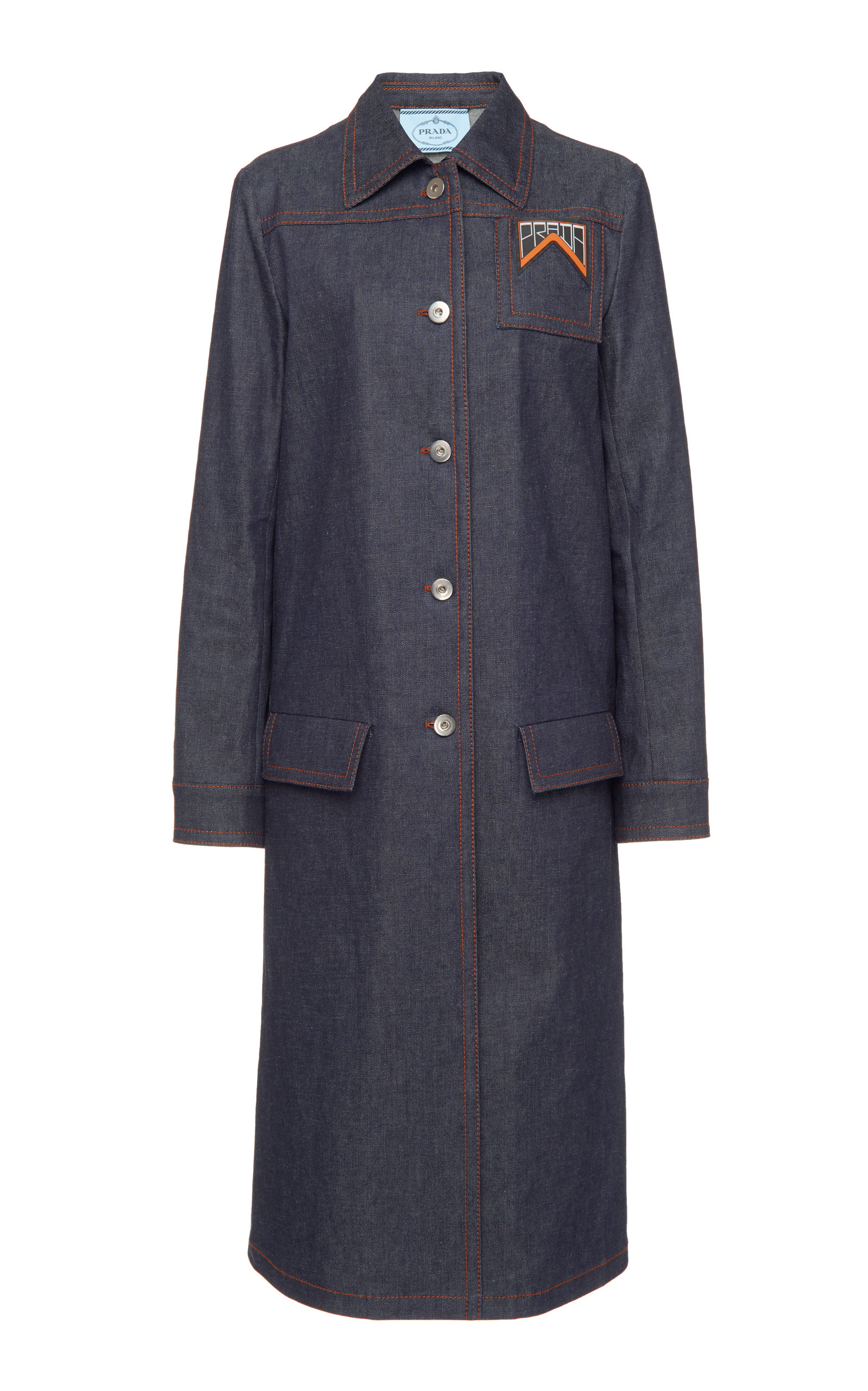 Prada's midi coat is crafted from raw denim with bright red contrast stitching. The structural piece