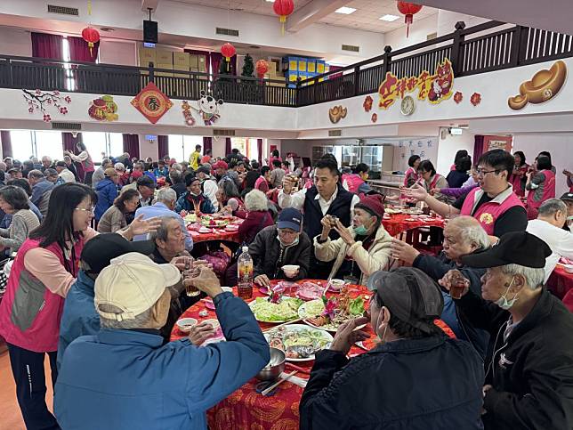 新北市立仁愛之家主任吳欽仁(中)向長輩敬茶 祝福龍年平安吉祥。（新北市社會局提供）