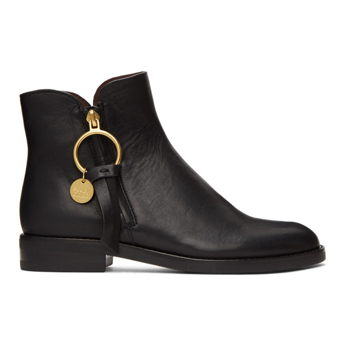 Ankle-high nappa leather boots in black. Round toe. Zip closure with leather trim and engraved logo 