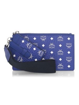 Allover logos adorn this zip pouch.; Top zip closure; Goldtone hardware; One interior slip pocket; O