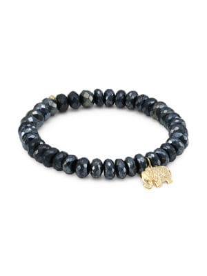 Crafted in luminous faceted black spinel, this beaded bracelet showcases a yellow gold elephant char