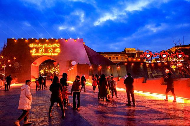 People visit the ancient city of Kashgar, northwest China's Xinjiang Uygur Autonomous Region, Feb. 5, 2024. With red lanterns decorated on streets, people can feel the festive atmosphere of the Spring Festival, or the Chinese Lunar New Year, in the ancient city of Kashgar. (Photo by Cai Zengle/Xinhua)