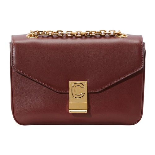 This Medium C bag in calfskin is by Celine. This piece's sliding chain enables you to wear it on the