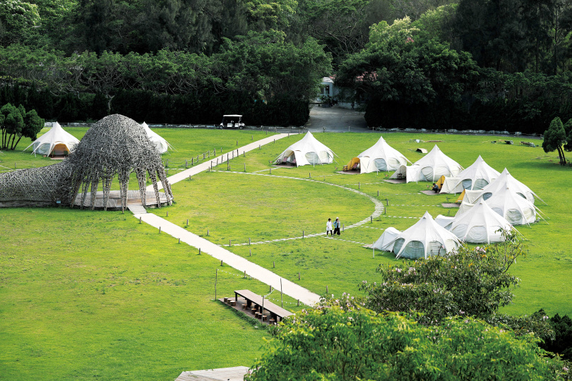 「山那村」的15頂白色帳篷，以半圓形方式環繞著《情天幕》。（圖／于魯光攝）