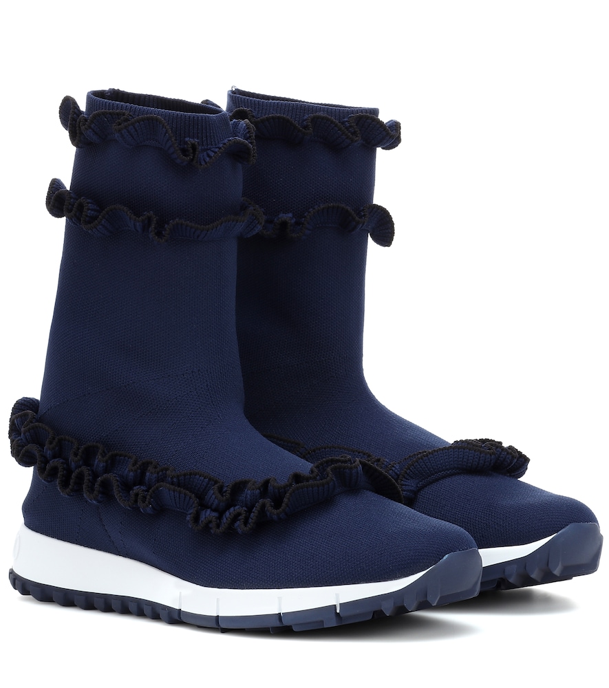 Jimmy Choo's Eugene is a playful ankle boot design in navy, featuring black ruffle details at the to