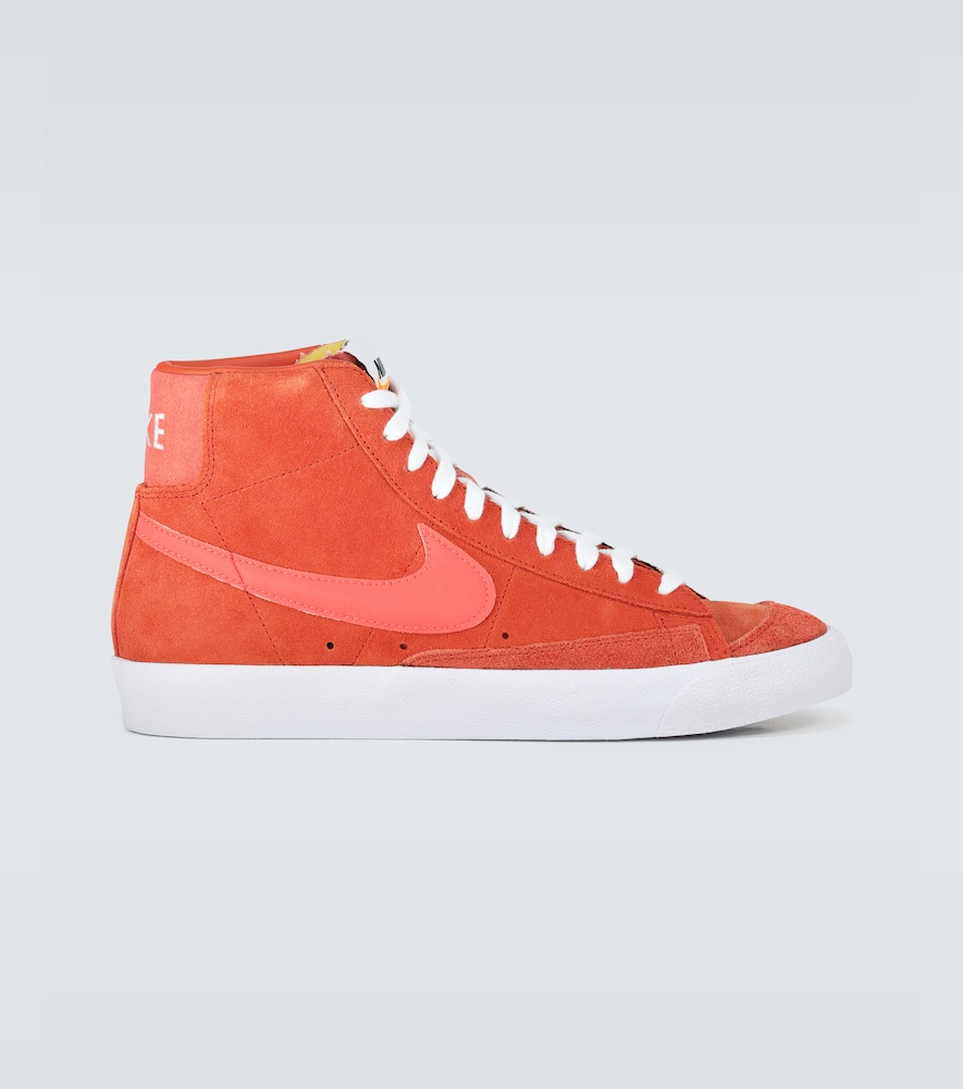 These high-top sneakers from Nike are crafted from soft suede in a bright orange, and feature the la