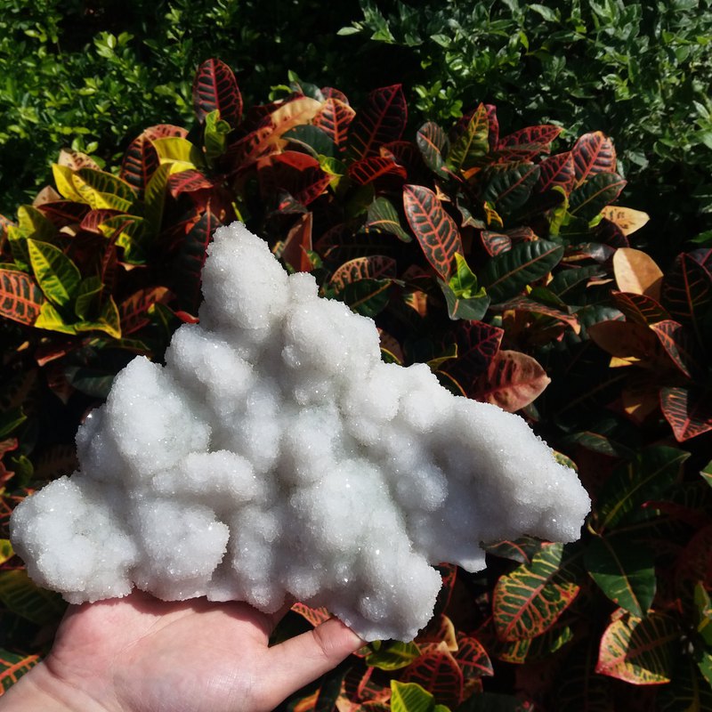 《被著白衣的螢石》表面佈滿白水晶的結晶，可以用來淨化水晶； 底部是綠螢石。白水晶的小結晶在日光下閃閃生輝，形狀也像一片雲朵，在外面亦能看到淡淡的綠色。