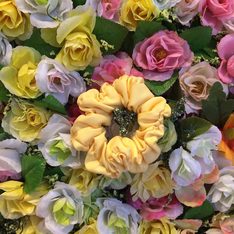 春天，金黃澄澄的向日葵 永遠迎向陽光，帶著笑吟吟地溫暖 一朵大腸花的故事， 是紮實的手感溫度，一針一線的細作，迎春待夏 紮起一落青絲，結成一朵花兒