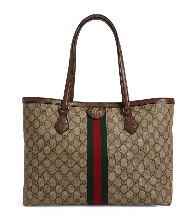 Crafted from smooth waxed canvas for an effortlessly luxurious look and feel, Gucci's capacious Ophidia tote bag will become a central part of your daily rotation. Elevated with the Italian House's signature motifs, the top-handle bag boasts the GG Supreme finish, Web stripe and polished gold-tone Double G hardware.