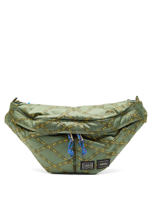 Aries - Aries and Porter's collaborative capsule features this khaki-green cross-body bag with yello