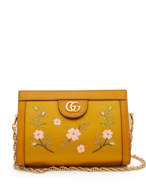 Gucci - Delicately embroidered in light pink sprigged florals, Gucci's yellow-ochre satin Ophidia shoulder bag exudes vintage charm. It's made in Italy to a boxy silhouette framed by snake trims, with a gold rope-chain strap that coordinates with the GG-logo plaque and it opens into two lined compartments. Carry it against a lustrous high-neck blouse and lace skirt to channel Alessandro Michele's 1940s-inspired mood.
