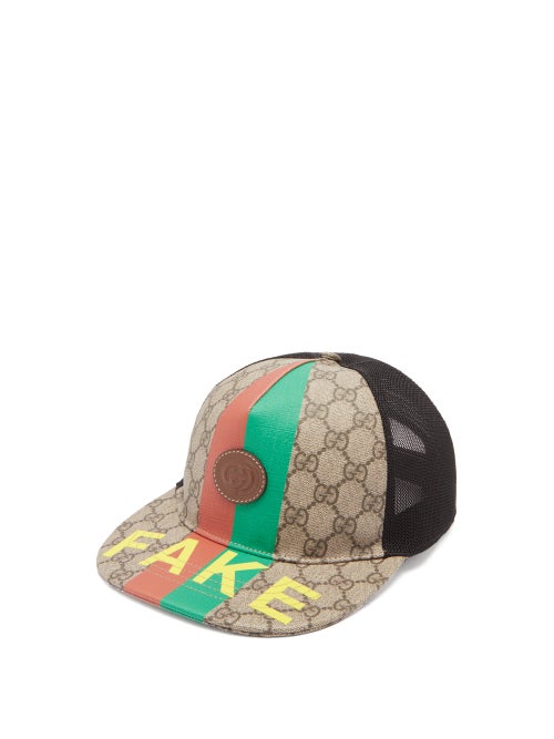 Gucci - Gucci takes an ironic approach to its products' illegitimate counterparts with the new Fake/Not logo, seen on the top and the underside of this hat's brim. It's crafted in Italy from the classic taupe-brown GG Supreme canvas printed with a green and red Web Stripe - two longstanding symbols of the house's heritage - and fastens with an adjustable leather strap before a breathable mesh back.