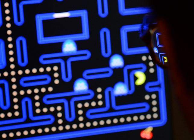 An employee plays the video game Pac-Man (1980) during an exhibition preview featuring 14 video games acquired by The Museum of Modern Art (MoMA) in New York on March 1, 2013. 
