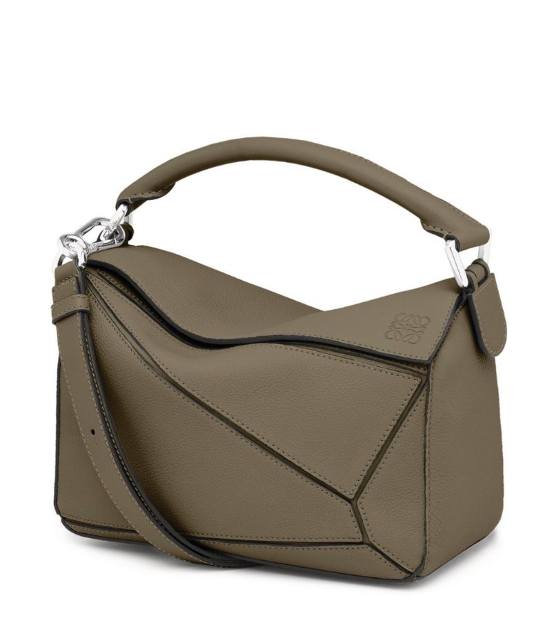 The first bag designed after Jonathan Anderson was appointed creative director in 2014, the Puzzle bag from LOEWE exudes modern artistry with its innovative cuboid shape that takes 524 actions to complete and perfect. Crafted from smooth leather and suspended from a chunky top handle, its defined by the segmented outer pattern and slouchy silhouette that can be conveniently folded completely flat for compact storage.