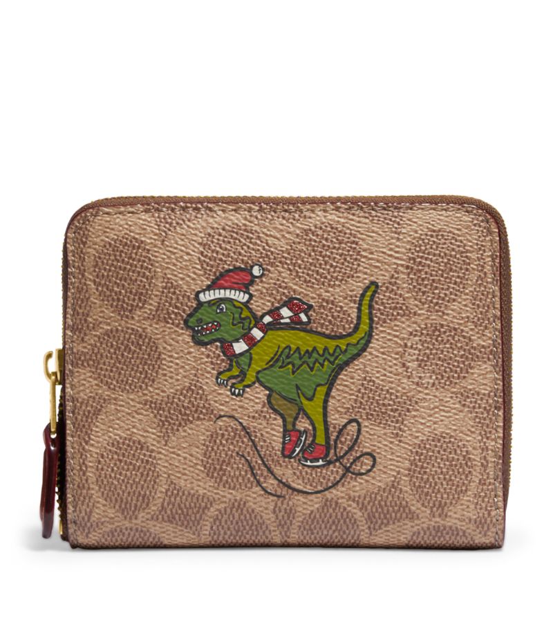 Characterised by a festive print of Rexy, the iconic Coach dinosaur, this essential zip-around walle