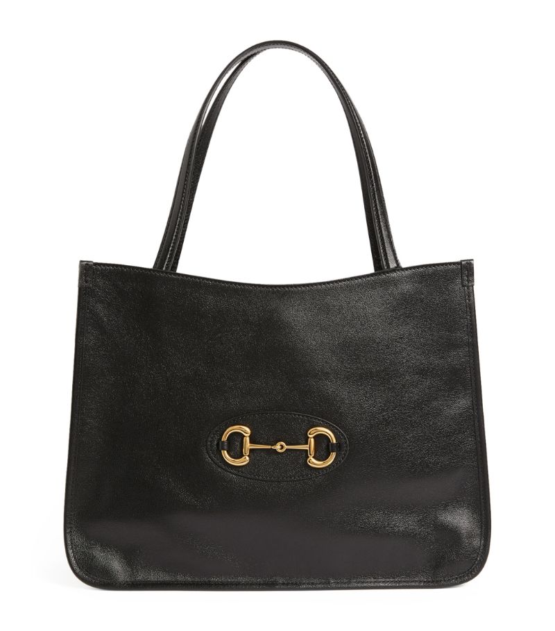 Characterised by hardware that dates back over six decades, the Gucci 1955 Horsebit collection is presented by creative director Alessandro Michele for a modern take on an archival design. Suspended from lengthy twin top handles for easy carrying, this spacious leather tote bag is perfect for everyday accessorising.