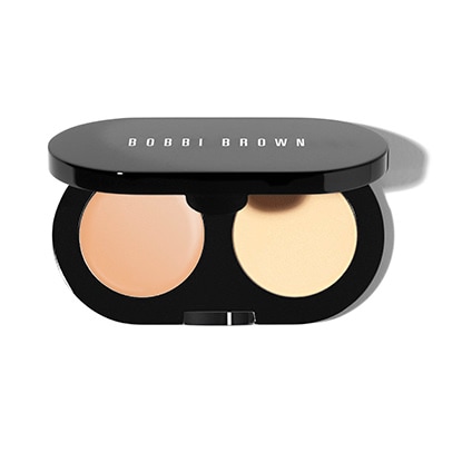Conceal and set in one portable kit. Bobbi Brown's Creamy Concealer blends easily to instantly cover