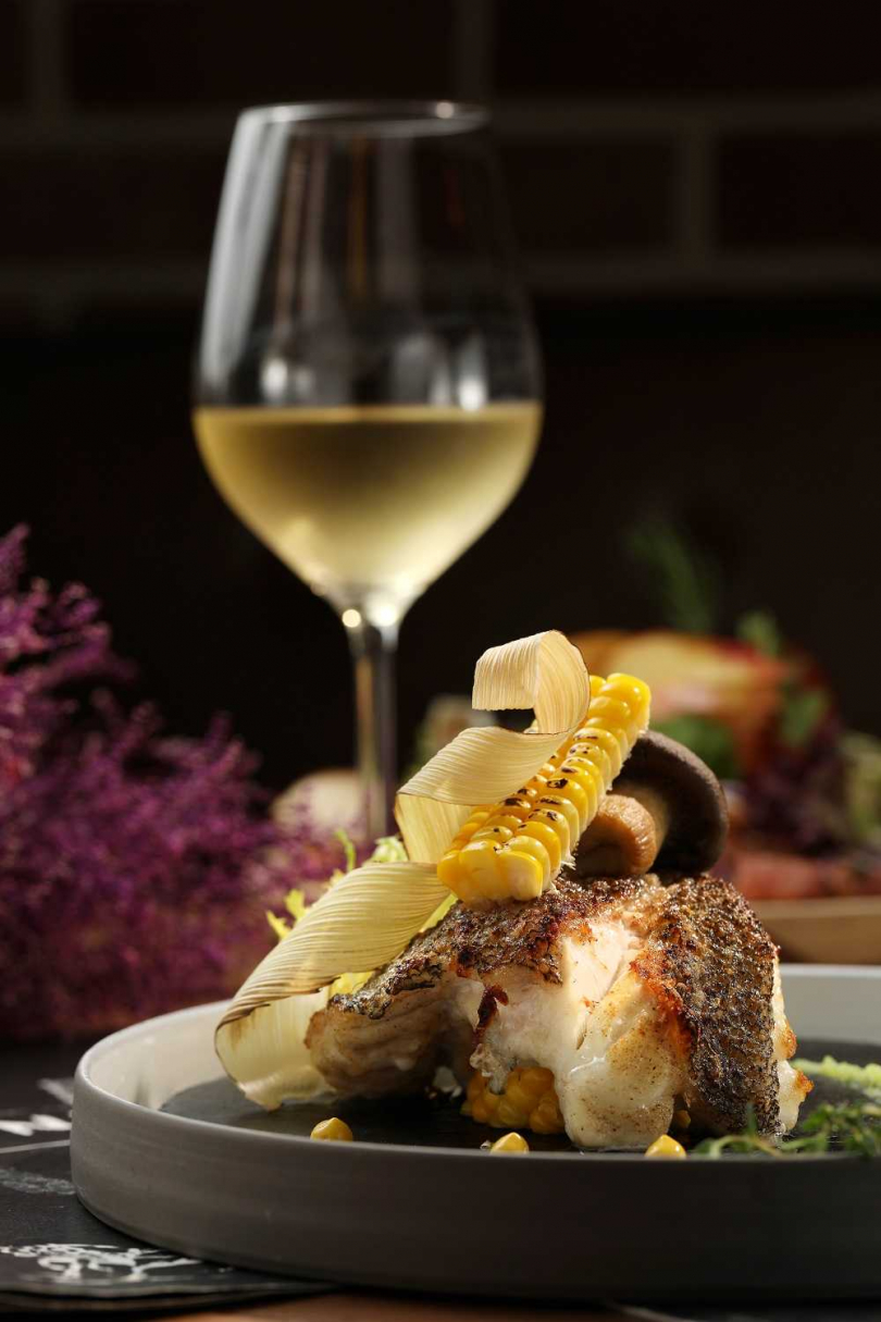 「長崎野石班魚爐烤佐黃檸檬碗豆醬」魚肉鮮甜細緻，與清爽帶有花果香氣的白酒非常相襯(680元) 。（圖／于魯光攝）