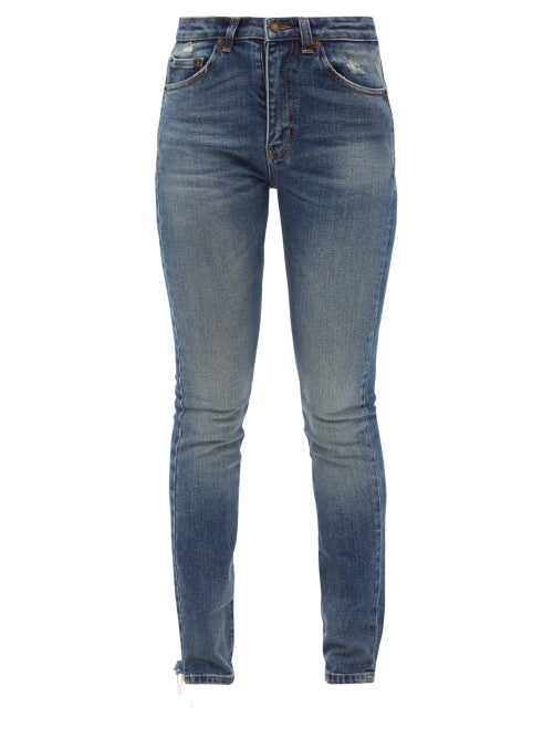 Saint Laurent - The faded wash and distressing of Saint Laurent's blue jeans is a nod to the Parisia