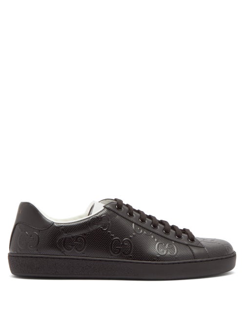Gucci - Gucci's black Ace trainers are embossed with the hallmark GG motif, elevating the staple sil
