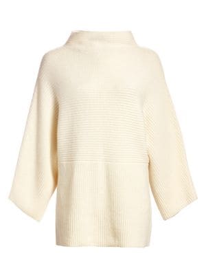 This cozy tunic sweater is crafted from lux cashmere that feels wonderfully soft against the skin. K