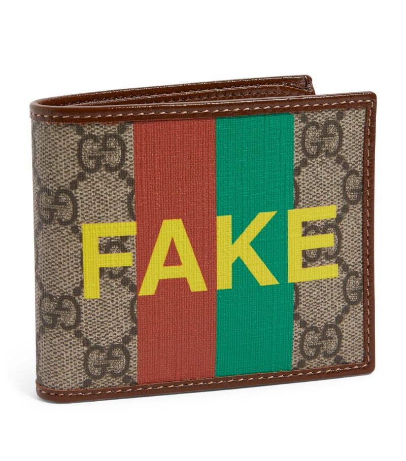 As one of the most coveted labels in the world of luxury, Gucci is often imitated, but never quite duplicated. The ironic design of this bifold wallet alludes to the Houses counterfeit replicas while simultaneously reassuring onlookers that it's 100% authentic with the words Fake and Not overpowering the iconic GG Supreme canvas and the printed Web stripe.