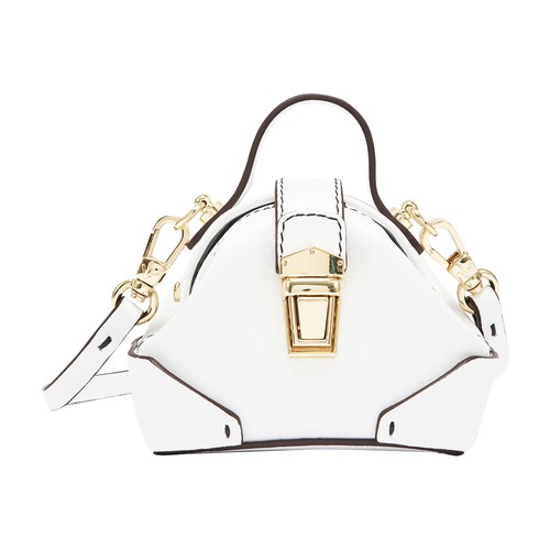 The Demi cross-body bag on a trapeze form by Manu Atelier features a long shoulder strap, a small ha