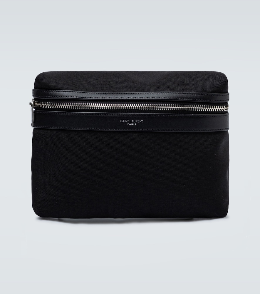 In a black canvas fabric, this small pouch bag from Saint Laurent has a zipped compartment and can b