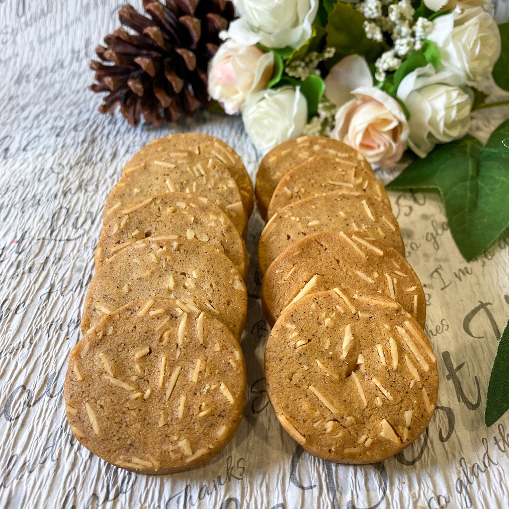 嚴選濃醇咖啡粉當原料，在麵粉助攻下，經過高溫烘烤的咖啡杏仁餅，散發陣陣濃郁的咖啡香，仔細一聞還會發現一股淡淡的稻禾氣息，還未入口聞著聞著就餓了。數十年的烘焙經驗，對於火侯的掌握更是恰到好處微焦的淺褐色