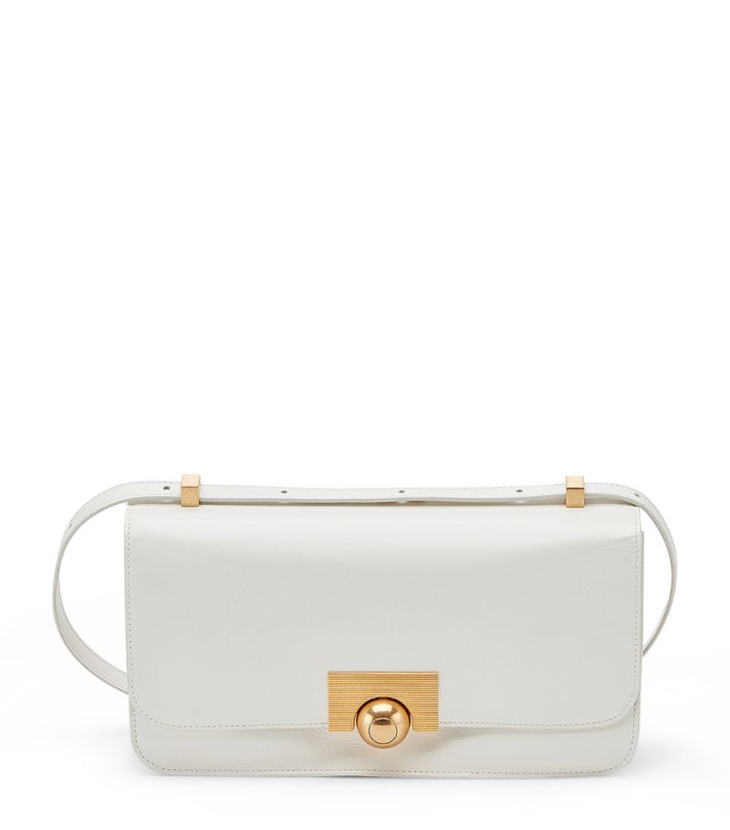 Renowned for its sleek line of accessories and sophisticated staples, Bottega Veneta presents the patent BV Classic shoulder bag. Boasting the exquisite Italian craftsmanship expected from the leather specialist, the lightly padded surface is punctuated with a luxurious gold-tone spherical button fastening. Finished with an adjustable shoulder strap, this ladylike style will effortlessly complement all of your favourite looks.