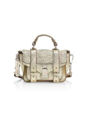 Highly detailed leather shoulder bag with a glamorous metallic finish.; Top handle; Foldover flap wi