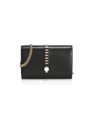 Edgy goldtone studding accents this skull leather mini bag.; Chain shoulder strap; Foldover flap wit