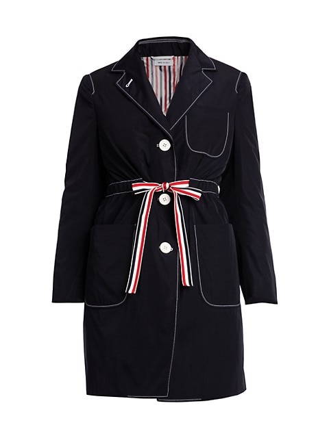 This technical gabardine overcoat is trimmed with signature varsity striped detailing that cinches a