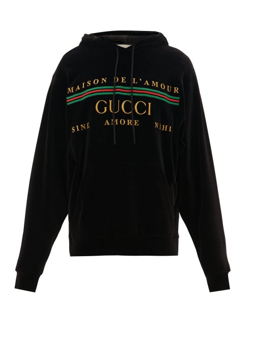 Gucci - Gucci's black velour hooded sweatshirt displays the label's signature typeface logo in bold 