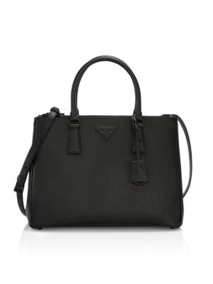 A Prada signature, this structured handbag is accented with an understated, tone-on-tone triangular 