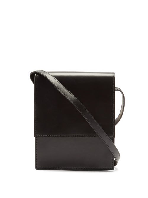 Lemaire - Seen in the AW20 presentation, Lemaire's black Satchel cross-body bag is cut to a boxy shape that echoes the collection's workwear-informed theme. It's made from polished leather with an adjustable shoulder strap that wraps around the silhouette and a large front flap that opens to a beige canvas lining.