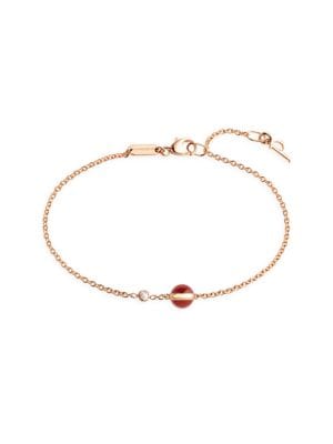 Rose gold bracelet with ornamental red carnelian stone. Colored bead adorned with Possession turning