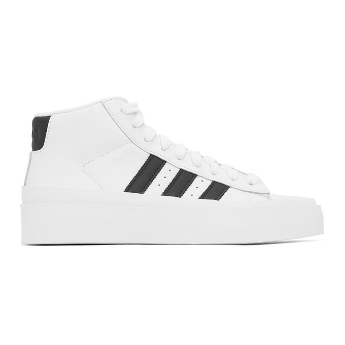 白色高帮运动鞋，采用抛光皮革面料。贝壳形橡胶圆头，同色系带。鞋舌金色徽标印花，软垫鞋领。黑色皮革后跟贴片饰有徽标压花，侧面黑色标志性条纹和穿孔细节。同色橡胶中底，同色纹理橡胶外底。424 x adid