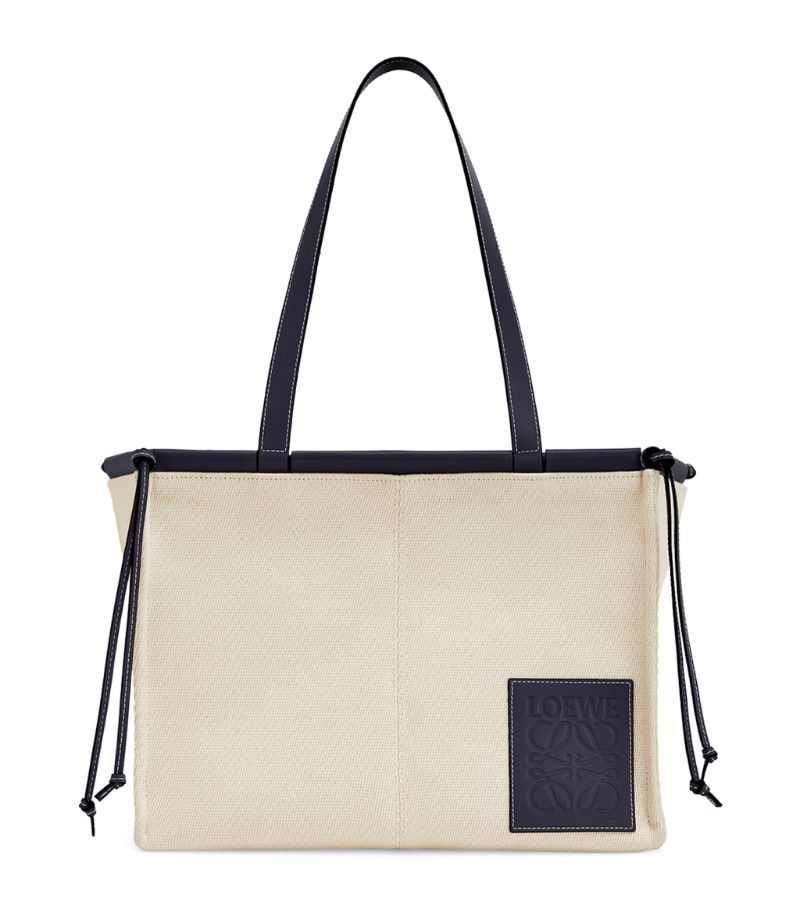 First introduced for Autumn/Winter 2019, LOEWEs Cushion bag boasts a precisely constructed and roomy framework, making it the perfect companion on your daily endeavours. Crafted from textural canvas with leather trims, the design - both practical and timeless - is characterised by the signature knotted ties and embossed Anagram logo patch.