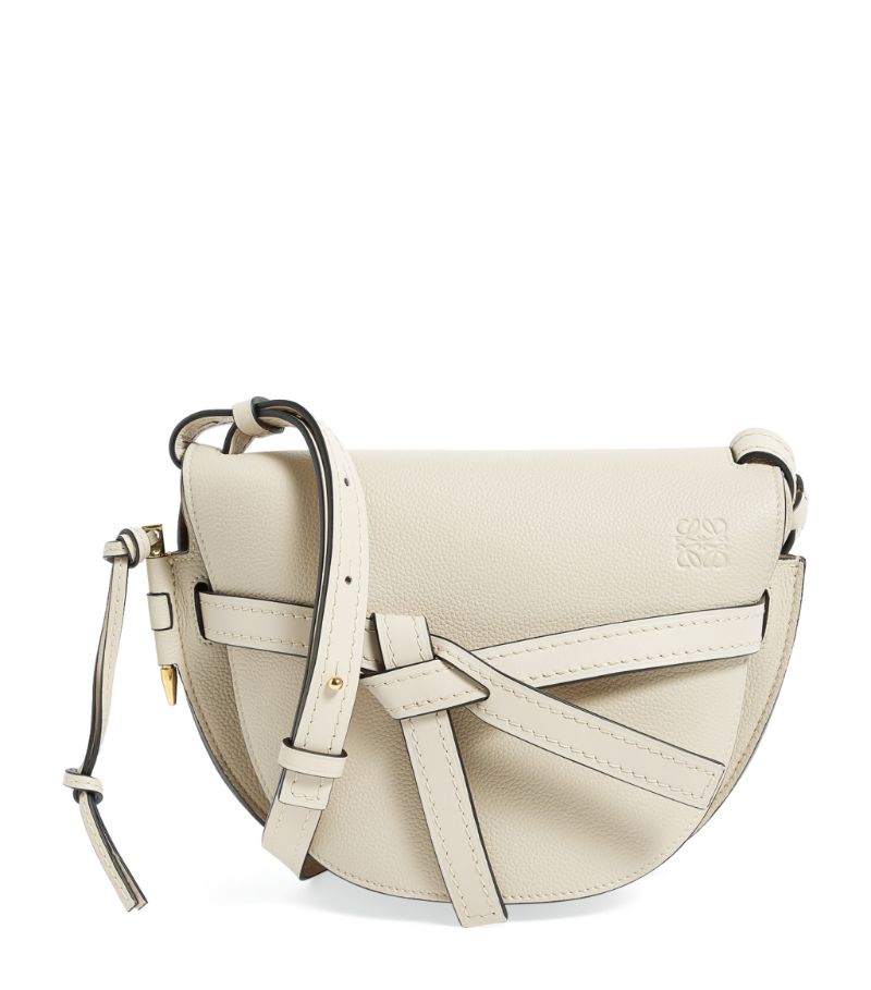 Owing its name to the side latched pin and knotted front belt closure, this LOEWE Gate bag is imagined in a cross-body style. With just enough space for the essentials, the saddle-shaped silhouette is timeless and versatile, crafted in soft leather to retain the structure. Finished with the iconic Anagram to the front, it boasts a sleek and refined finish.