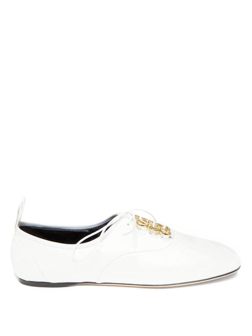 Loewe - The lyrical gold Anagram plaque adorning Loewe's white oxford flats was designed in 1970 by 