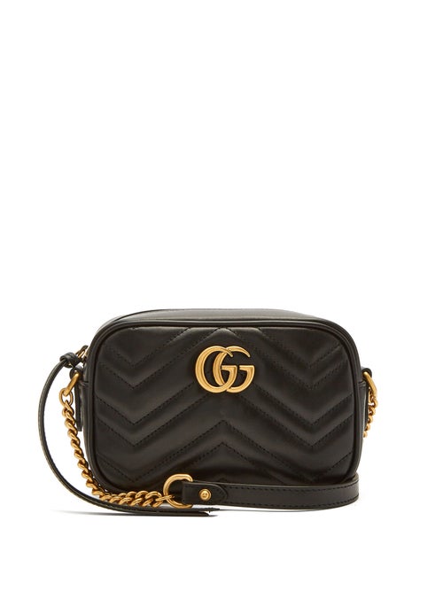Gucci - Mini bags continue to reign this season and Gucci's black leather GG Marmont version has cult appeal, originally named after the Chateau Marmont hotel on Sunset Boulevard. It's crafted in Italy with a quilted exterior in the recognisable chevron pattern, and an antiqued gold-tone GG front plaque - an original house motif first designed in 1933 - with a matching chain on the leather shoulder strap.