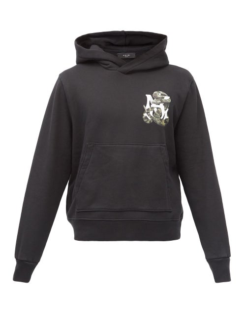 Amiri - The white logo print of Amiri's black hooded sweatshirt is entwined with a sinuous serpent, 