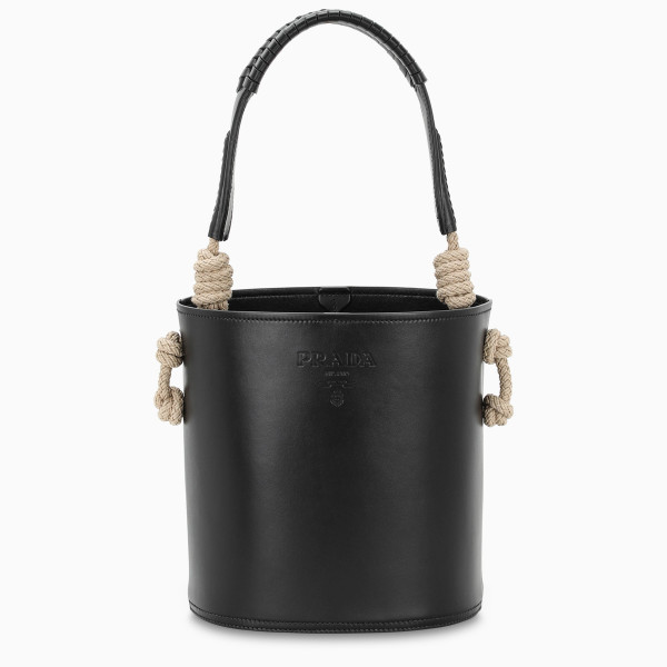 Bucket bag by Prada in black leather, featuring a rope and braided leather handle, an adjustable and detachable leather shoulder strap, a hot-stamped logo detail to the front, a leather lace fastening and an interior slip pocket.