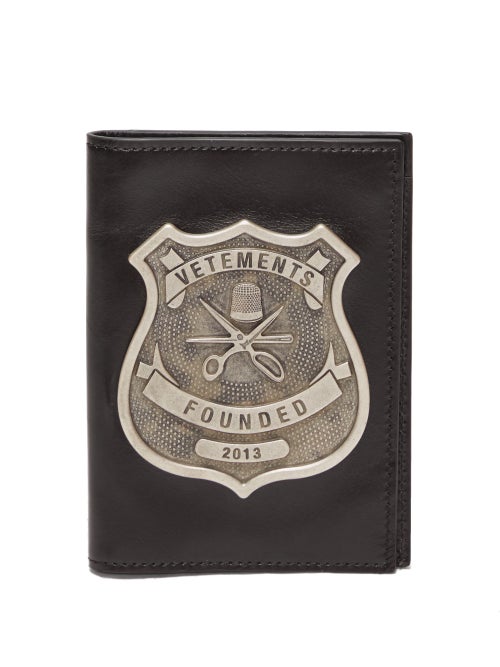 Vetements - The antiqued silver-tone metal plaque set on this black passport holder is an example of